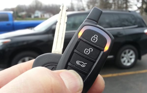 Car Key Fob with Remote Car Starter icon pointed in front of car.